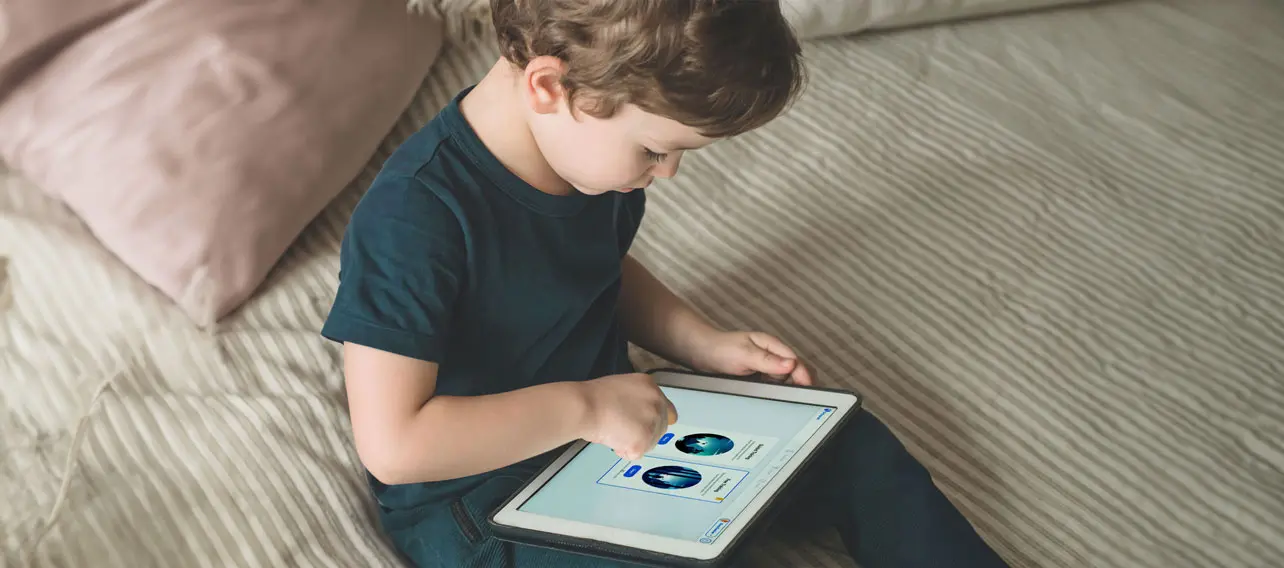 Boy holding a tablet with Grafari app