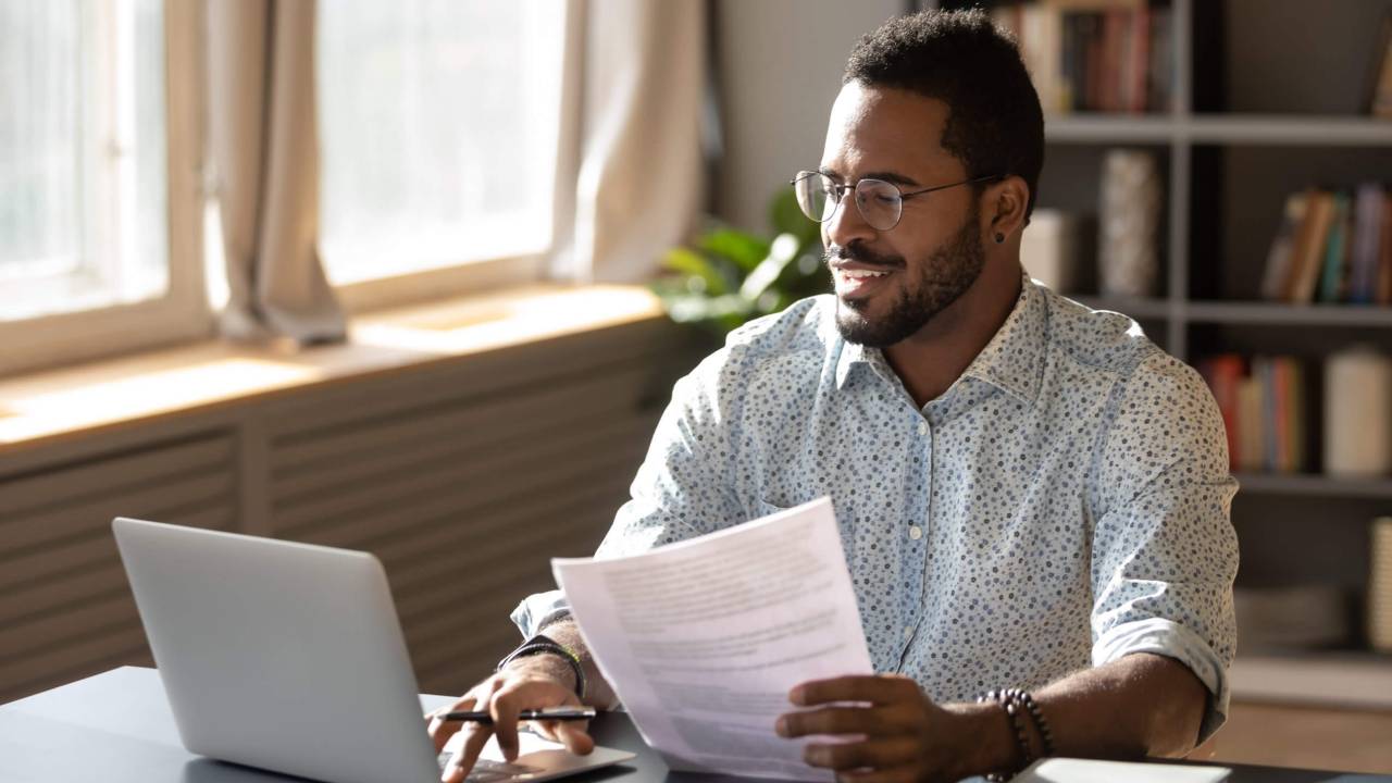 A man using a laptop for his certification process