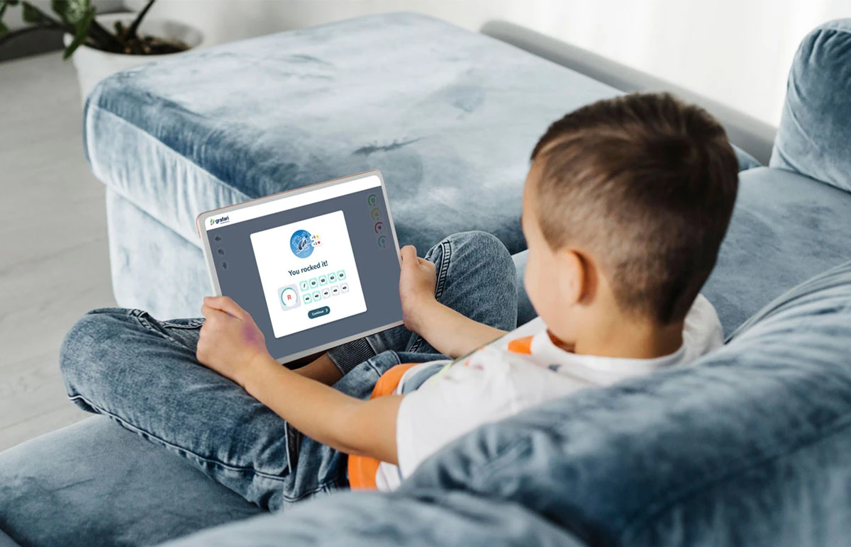 a boy learning with Grafari using a tablet