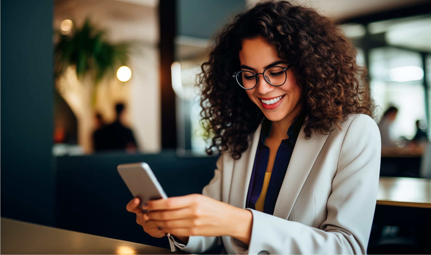 a smiling woman looking at her phone