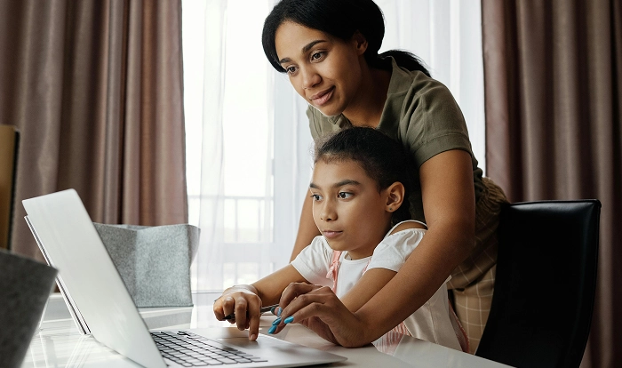 a mother helping her daughter with studying